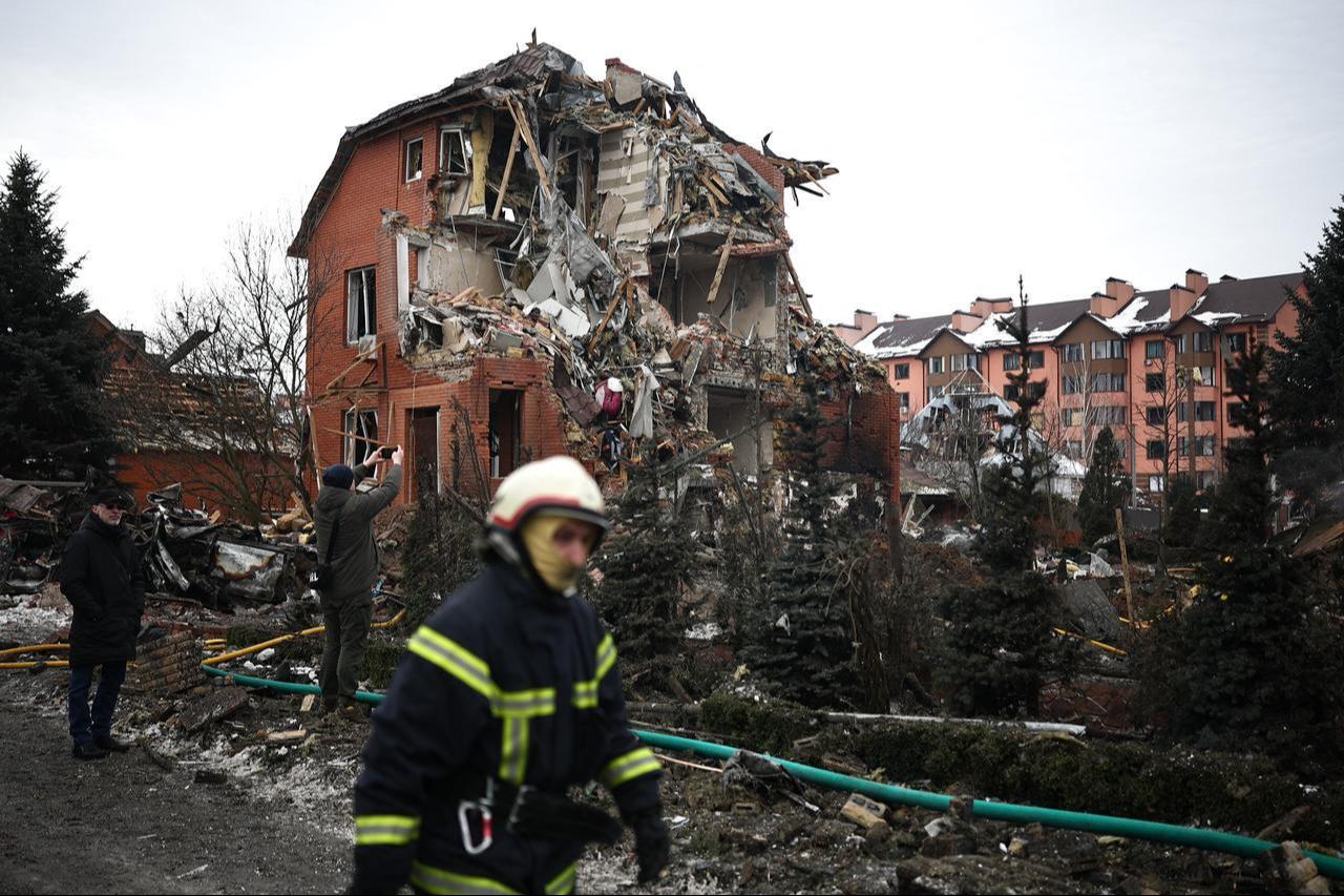 A Ukrainian rescuer walks past a heavily damaged house following an air attack in Sofiivska Borshchagivka, Kyiv region, Ukraine on February 22, 2026. (AFP Photo)