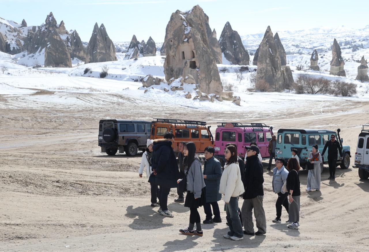 Tourists enjoy a jeep safari in Cappadocia as bad weather halts hot air balloon flights in Nevsehir, Türkiye, Feb. 17, 2025.