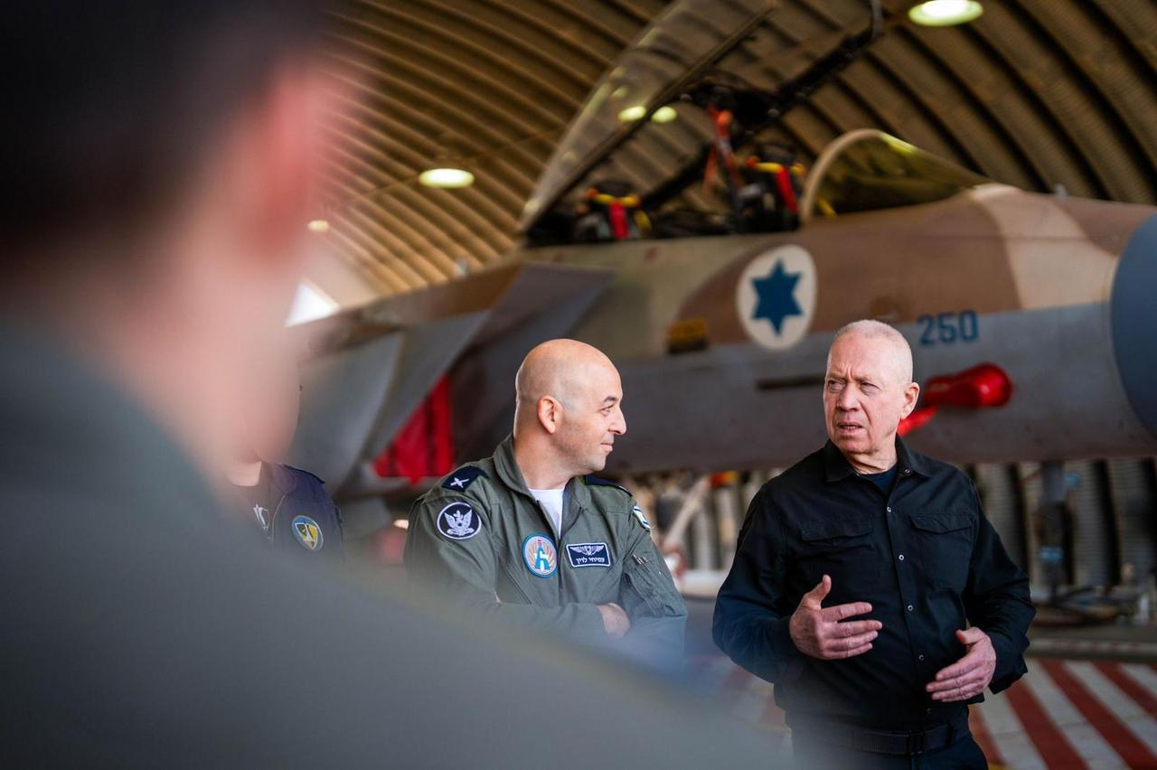 Israel Defense Minister Yoav Gallant (right) speaks to Israeli Air Force pilots and crews at the Hatzerim Airbase, October 22, 2024. (Ariel Hermoni/Israel Defense Ministry Photo)