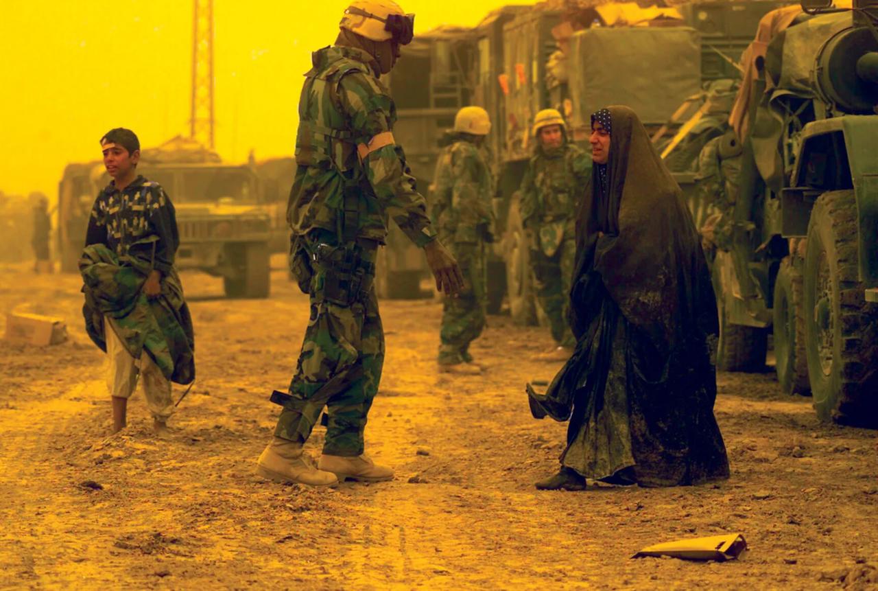 U.S. marines assisting displaced Iraqi civilians north of Al-Nāṣiriyyah, Iraq, during the Iraq War. (Photo via US Department of War)