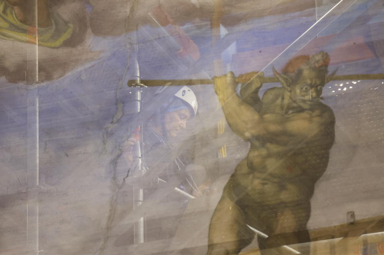 A conservator works on Michelangelo’s The Last Judgement fresco during restoration inside the Sistine Chapel at the Vatican, Feb. 28, 2026. (AA Photo)