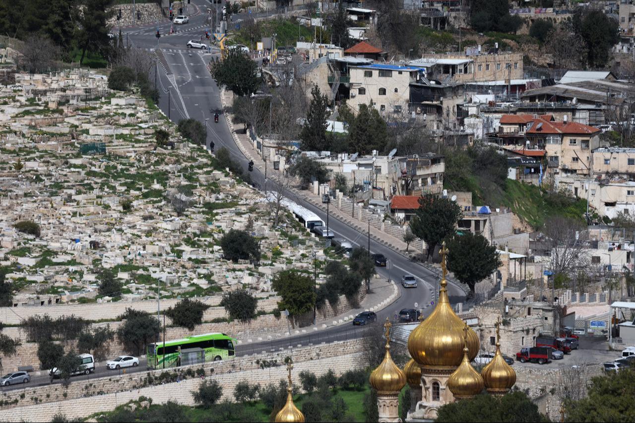 This picture shows a view shows traffic moving on a street in Jerusalem with the Russian Church of Mary Magdalene (bottom-R) on February 28, 2026. (AFP Photo)