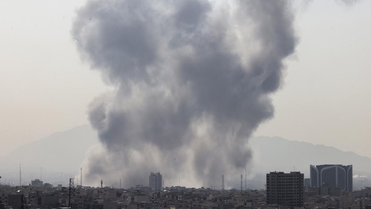Smoke columns rise in Tehran in first images after Israeli strike