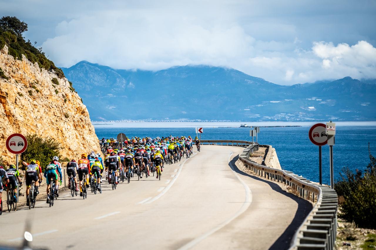 The peloton rides along the Mediterranean coastline during an earlier Tour of Antalya stage. (Photo via Tour of Antalya)