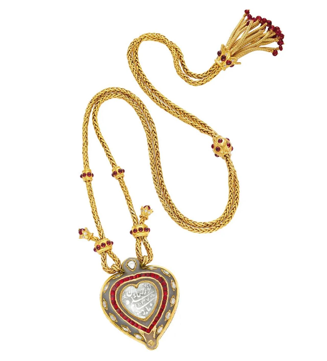The heart-shaped, table-cut diamond bears a Persian inscription and is set within a gold, ruby, and jade mount. (Photo via Christie’s)
