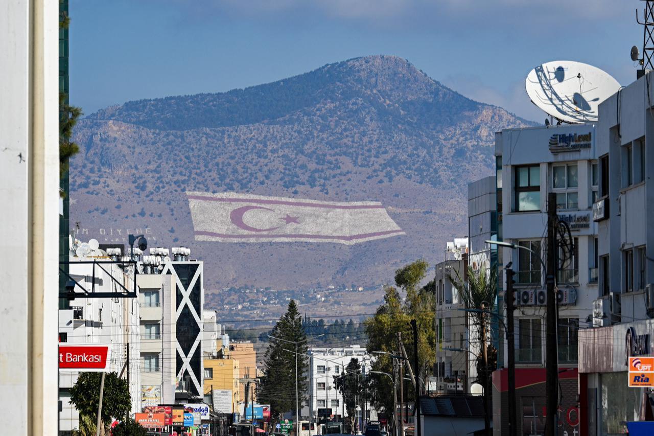 A view of a TRNC flag on the Besparmak Mountains ahead of the first round of the presidential election, where eight candidates will compete on Sunday in Lefkosia, Turkish Republic of Northern Cyprus on October 17, 2025. (AA Photo)