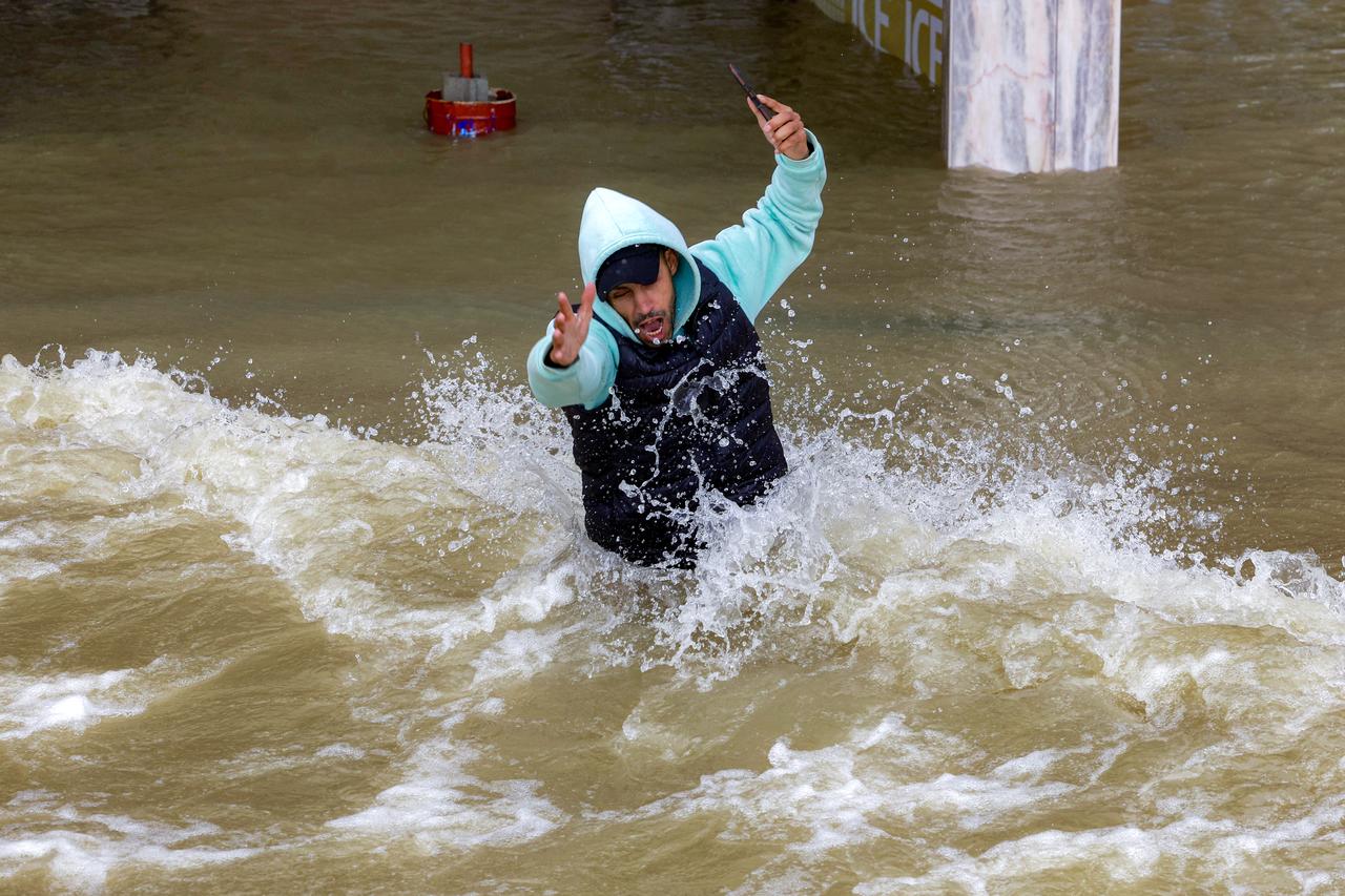 A man reacts as he moves through an inundated street in Morocco's northwestern city of Ksar el-Kebir on January 29, 2026.( AFP Photo)