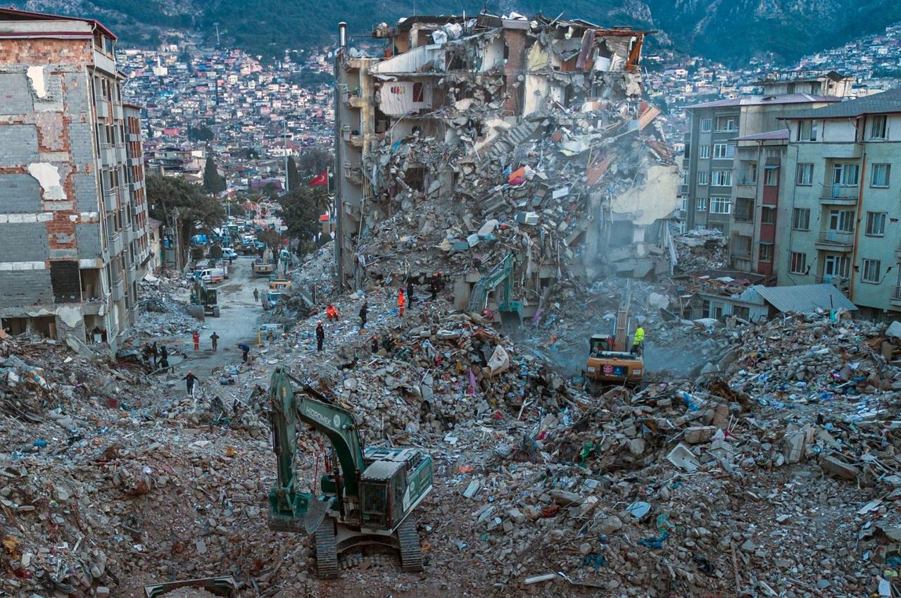 This aerial photo shows diggers removing the rubble of collapsed buildings in Antakya, Türkiye's southern province of Hatay, on February 20, 2023. (AFP Photo)