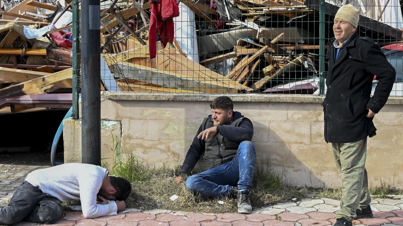 People grieve near collapsed building in Hatay, Türkiye, February 7, 2023. (AA Photo)