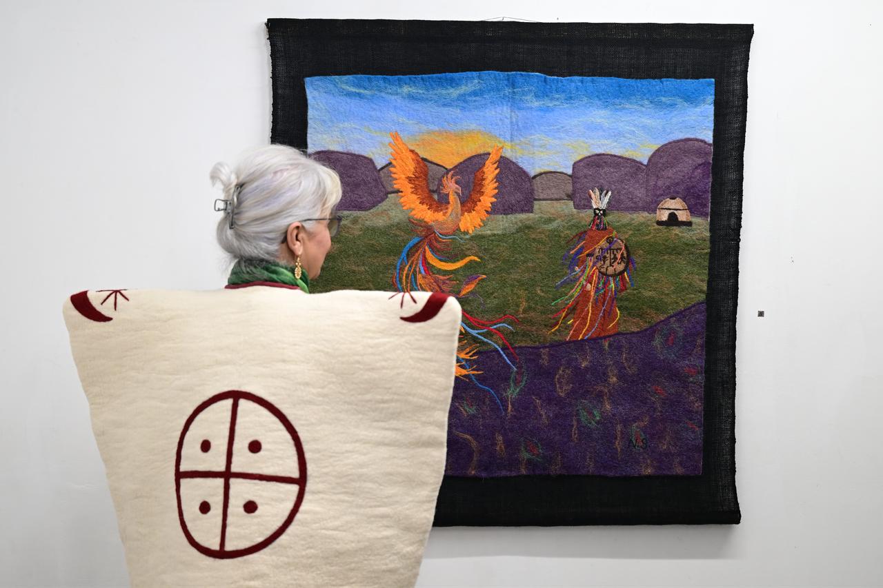 Patroglyph-inspired symbols, including animals and hunting scenes, are reimagined through traditional felt techniques. (AA Photo)