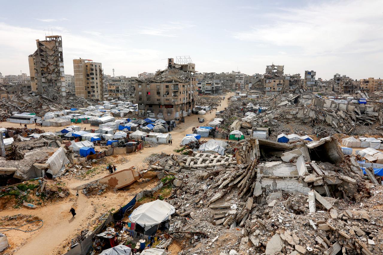 Tents sheltering Palestinians displaced by conflict are pictured by destroyed and heavily-damaged buildings in the Muqusi area of Gaza City, February 7, 2026. (AFP Photo)