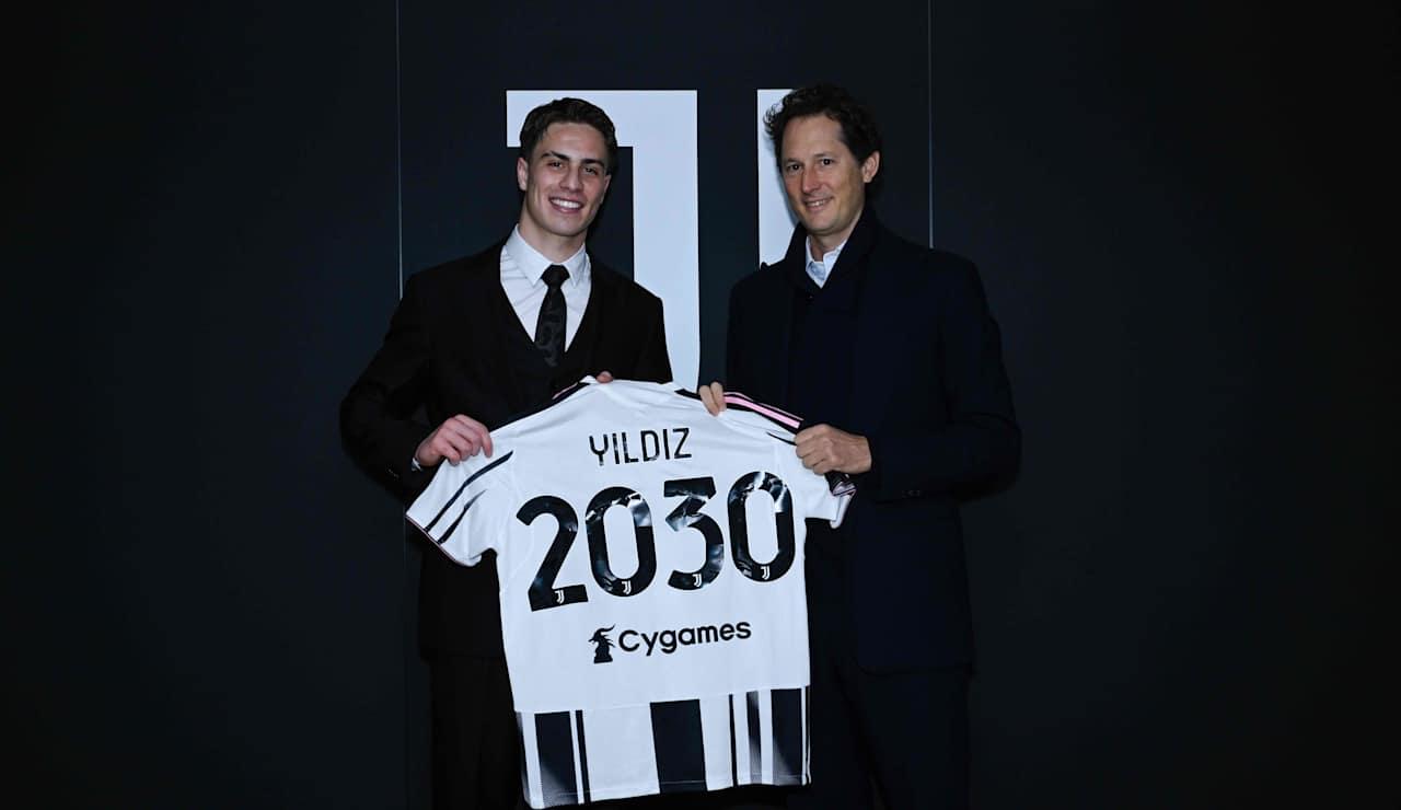 Kenan Yildiz (L) holds a Juventus shirt marked "2030" alongside John Elkann (R) during the signing ceremony for his new contract with the club in Turin, Italy, Feb. 7, 2026. (Photo via Juventus)
