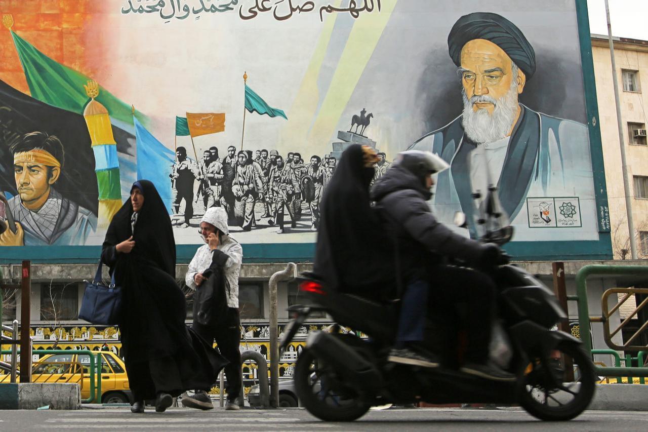 Women walk on the street with posters depicting Supreme leader of Iran Ali Khamenei, as daily life in the Iranian capital, Tehran, continues Iran, Feb. 9, 2026. (AA Photo)