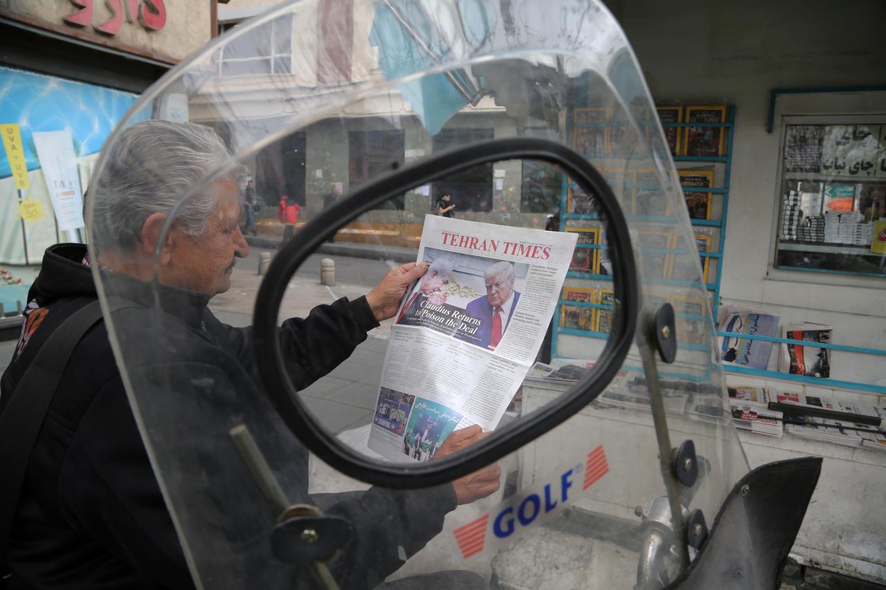 A man reads a newspaper as daily life in the Iranian capital, Tehran, continues on February 9, 2026. (AA Photo)