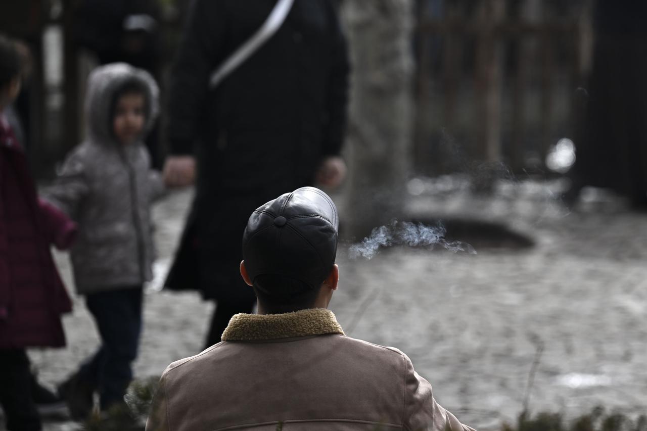 A man smokes a cigarette outdoors as visible smoke rises into the cold air in Ankara, Türkiye, February 7, 2026. (AA Photo)
