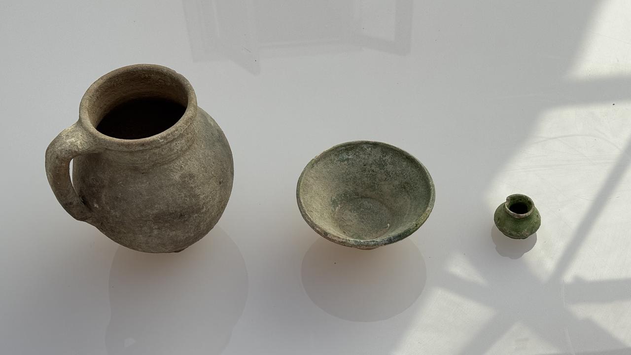 Ceramic vessels uncovered during excavations at Lystra, including a green-glazed Seljuk-era inkwell found alongside the bronze amulet, Feb. 9, 2026. (AA Photo)