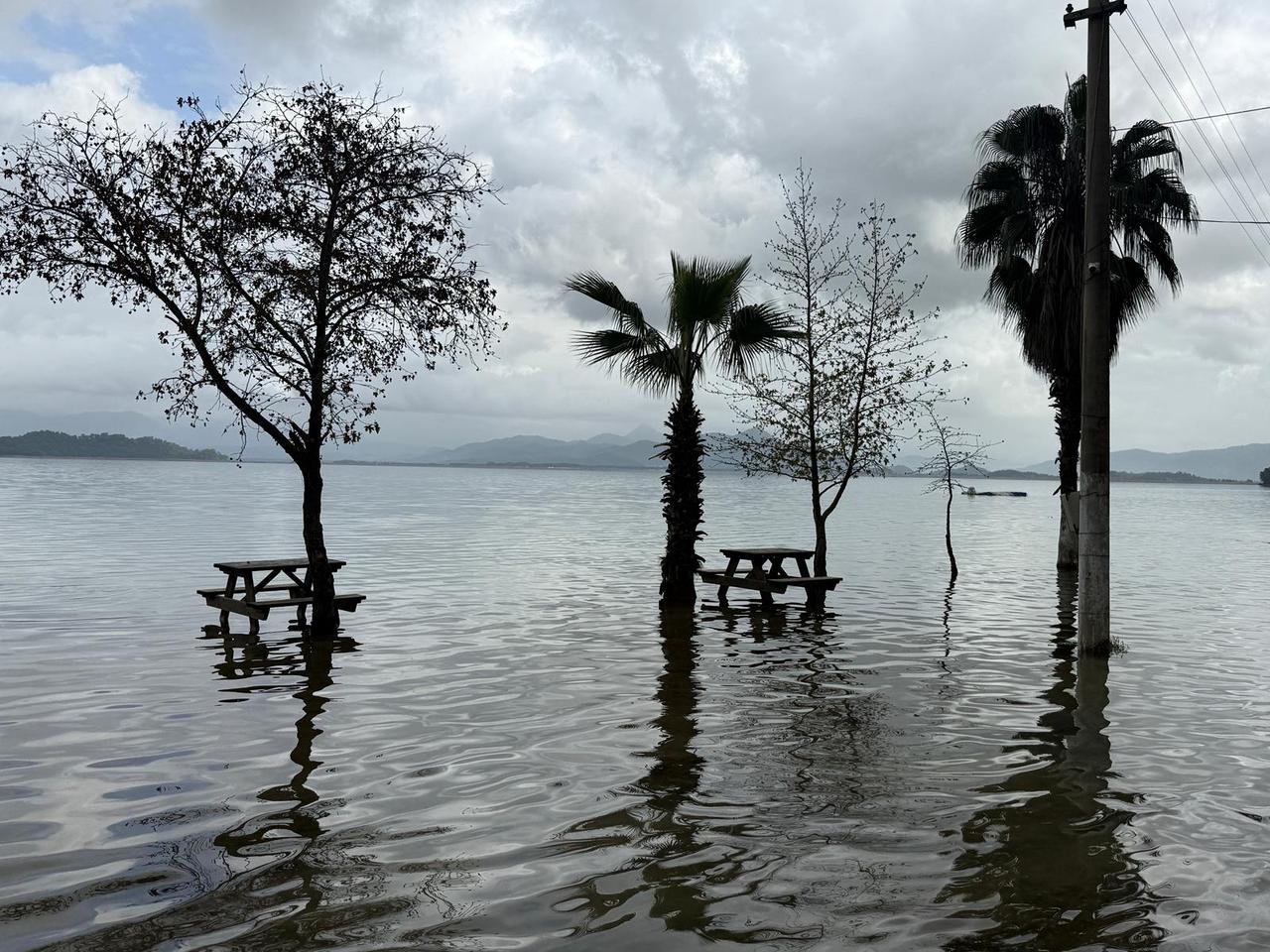 Floodwaters cover picnic tables and trees along the shore of Koycegiz Lake in southwest Türkiye after heavy rainfall caused the lake to overflow, pushing water into normally dry public areas., Feb. 8, 2026. (AA Photo)