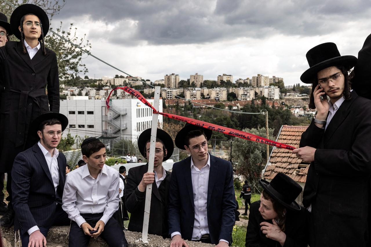 Ultra-Orthodox Jewish men look on at the scene of a missile attack on Bet Shemesh, some 30 kilometres west of Jerusalem on March 1, 2026. (AFP Photo)
