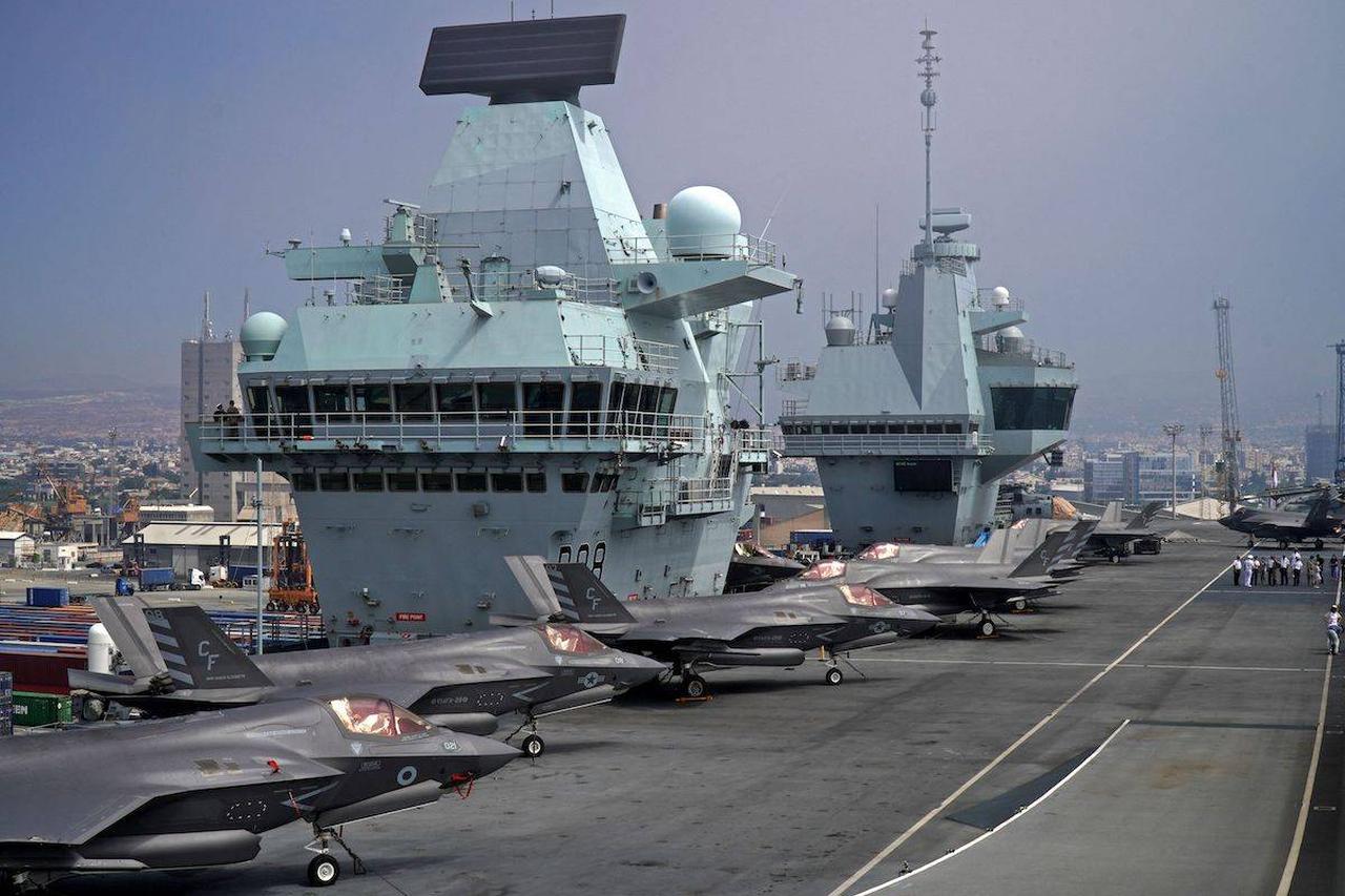 This picture, taken on July 1, 2021, shows a view of Royal Navy and US Marine Corps F-35B Lightning multirole combat aircraft parked aboard the deck of the Royal Navy's HMS Queen Elizabeth aircraft carrier. (AFP Photo)