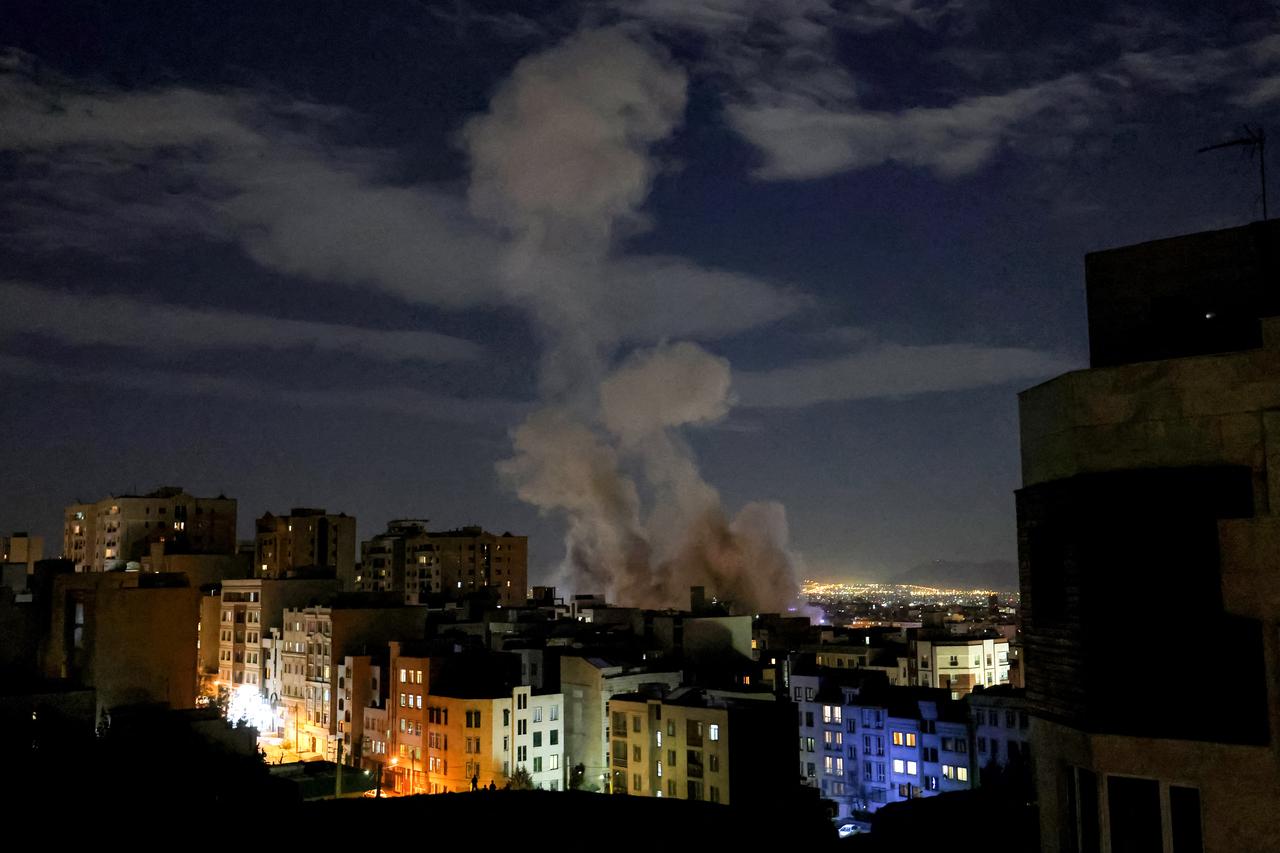 A smoke plume rises following a missile strike on a building in Tehran, Iran on March 1, 2026.(AFP Photo)