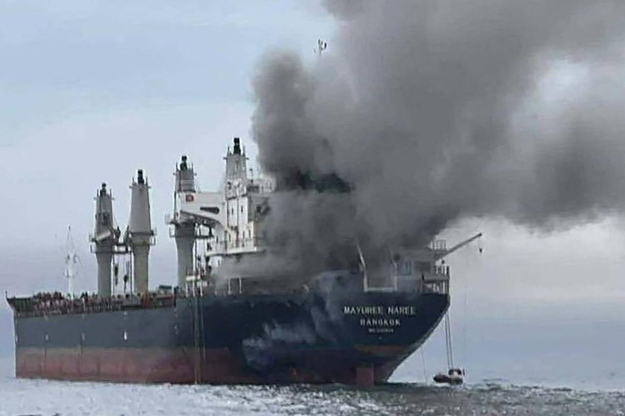 This handout photo taken on March 11, 2026 and released by the Royal Thai Navy shows smoke rising from the Thai bulk carrier 'Mayuree Naree' near the Strait of Hormuz after an attack. (AFP Photo)