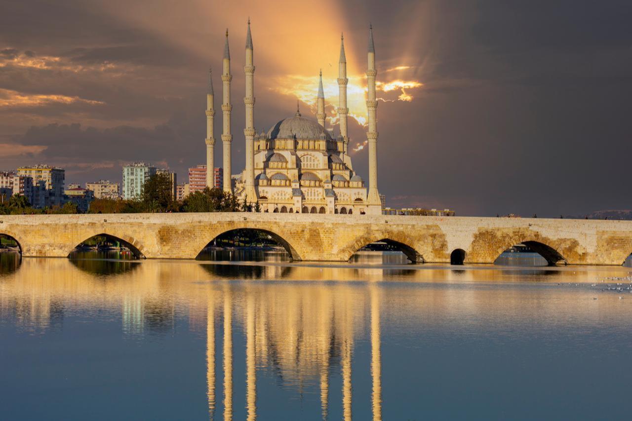 The Stone Bridge (known as Taskopru in Turkish) alongside Sabanci Central Mosque, Adana, Türkiye. (Adobe Stock Photo)