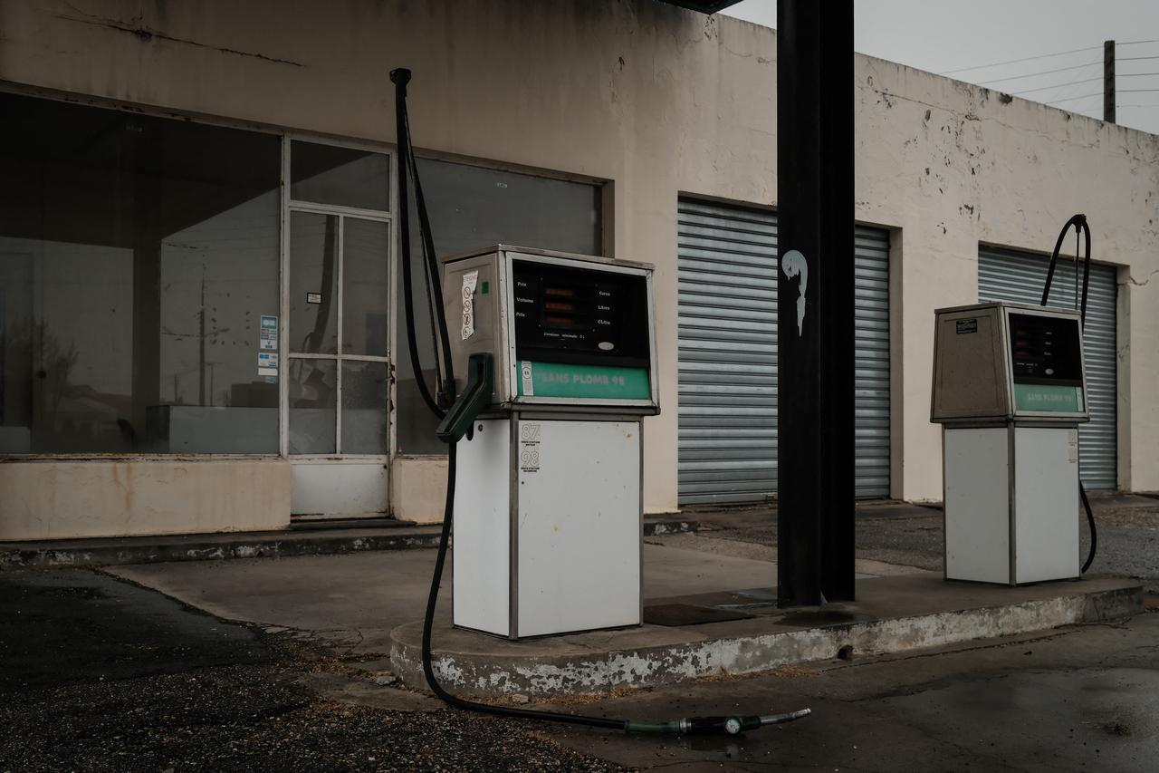Dangling pipes and idle pumps are seen at an abandoned gas station in Ambès, near Bordeaux, southwestern France on March 11, 2026. (AFP Photo)