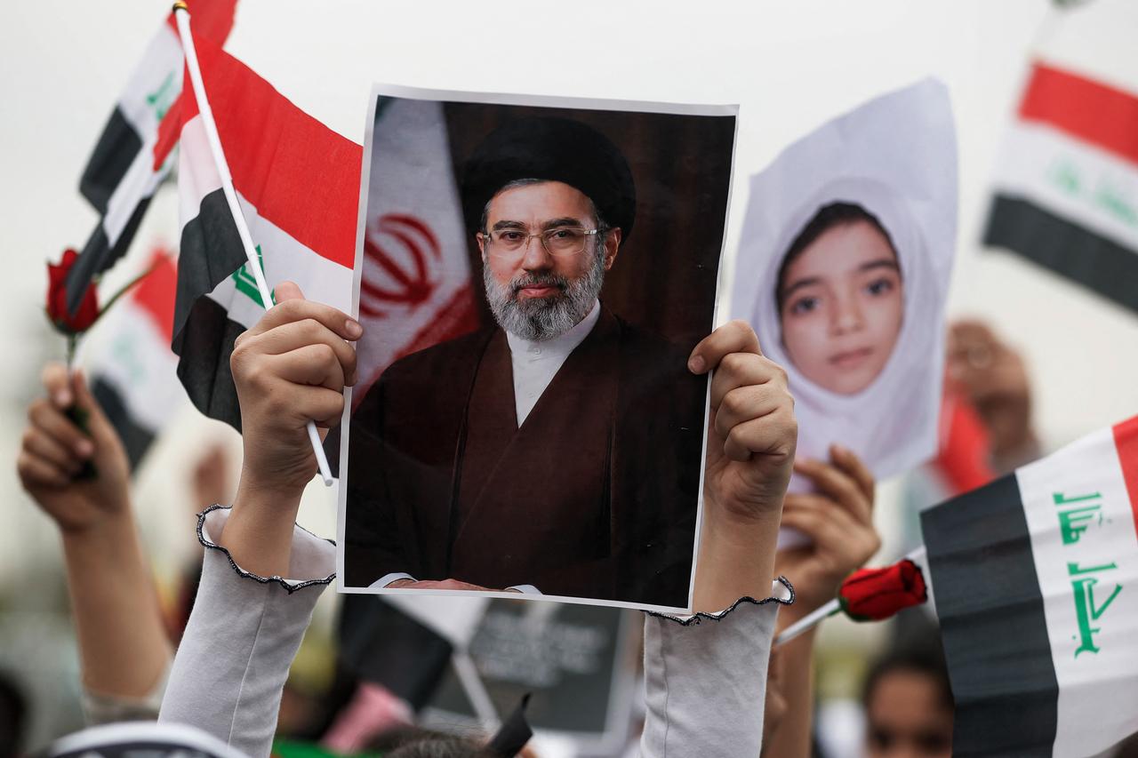 A schoolgirl holds up a poster of Iran's new supreme leader Mojtaba Khamenei during an anti-US and Israel demonstration in Baghdad, Iraq on March 12, 2026. (AFP Photo)