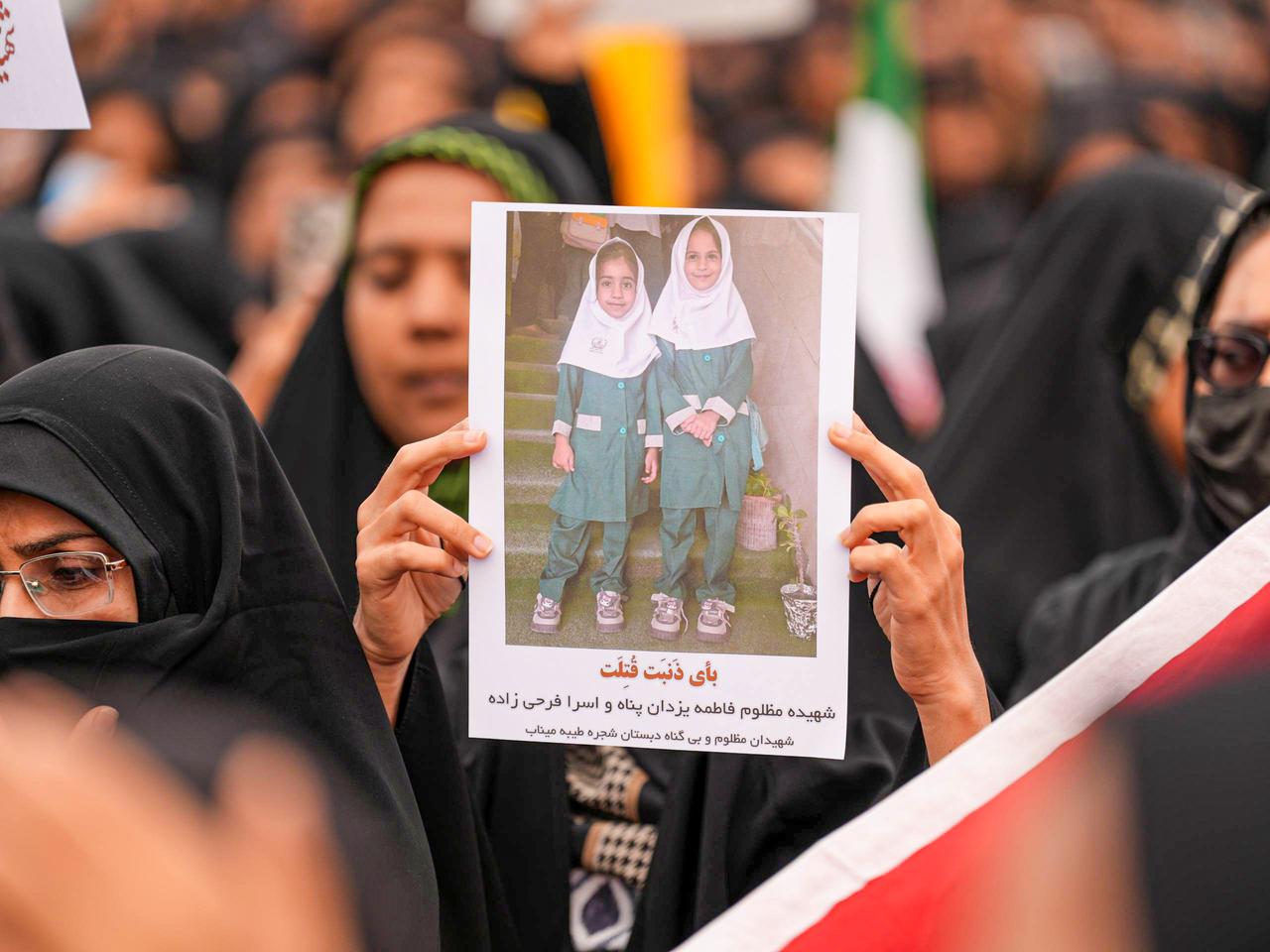 Mourners hold a portrait of a students during a funeral ceremony for children, who were killed after a primary school in Iran's Hormozgan province was targeted by the US-Israel, March 3, 2026, in Minab, Iran. (AA Photo)