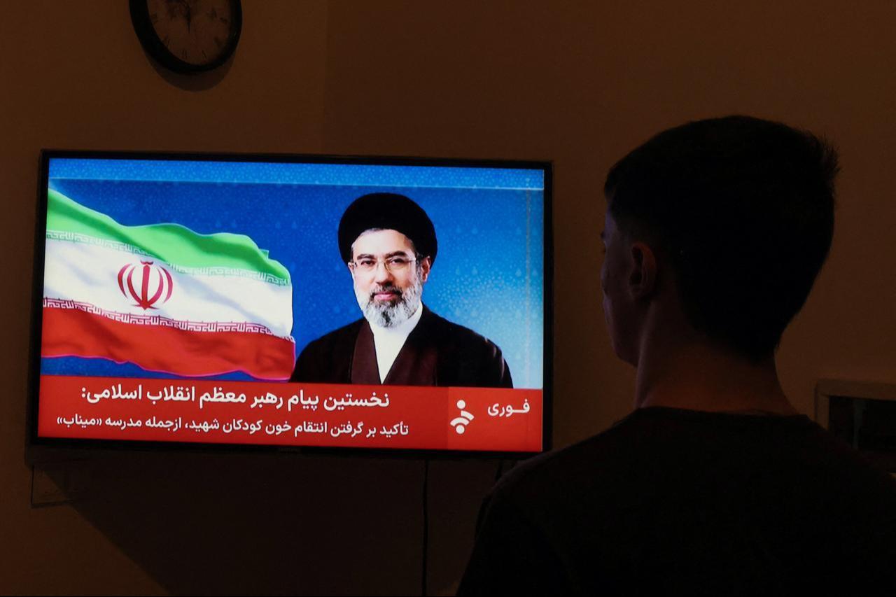 A man watches a televised statement by Iran's new supreme leader, Mojtaba Khamenei, on March 12, 2026. (AFP Photo)