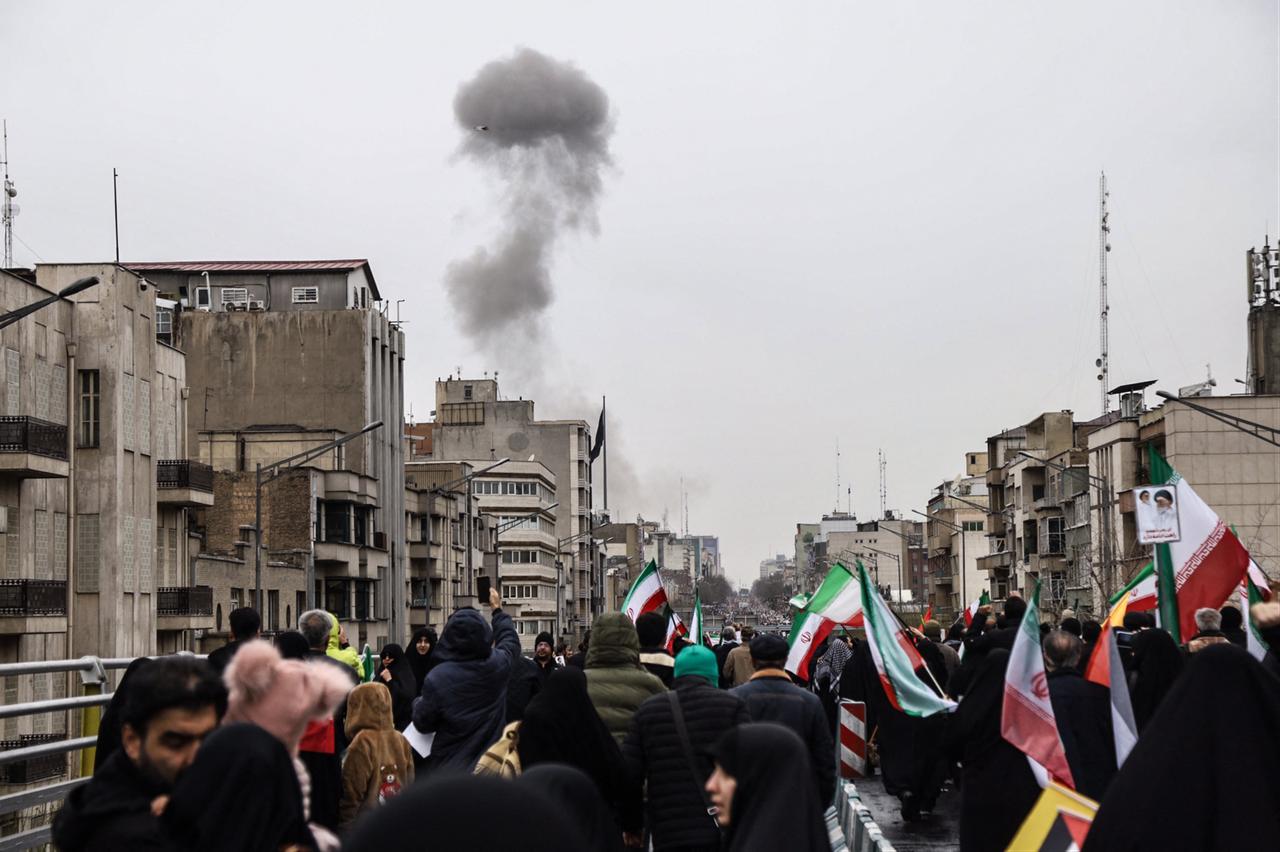 Black smoke rises following an airstrike, as Iranians take part in the Al-Quds (Jerusalem) Day rally in Tehran on March 13, 2026. (AFP Photo)
