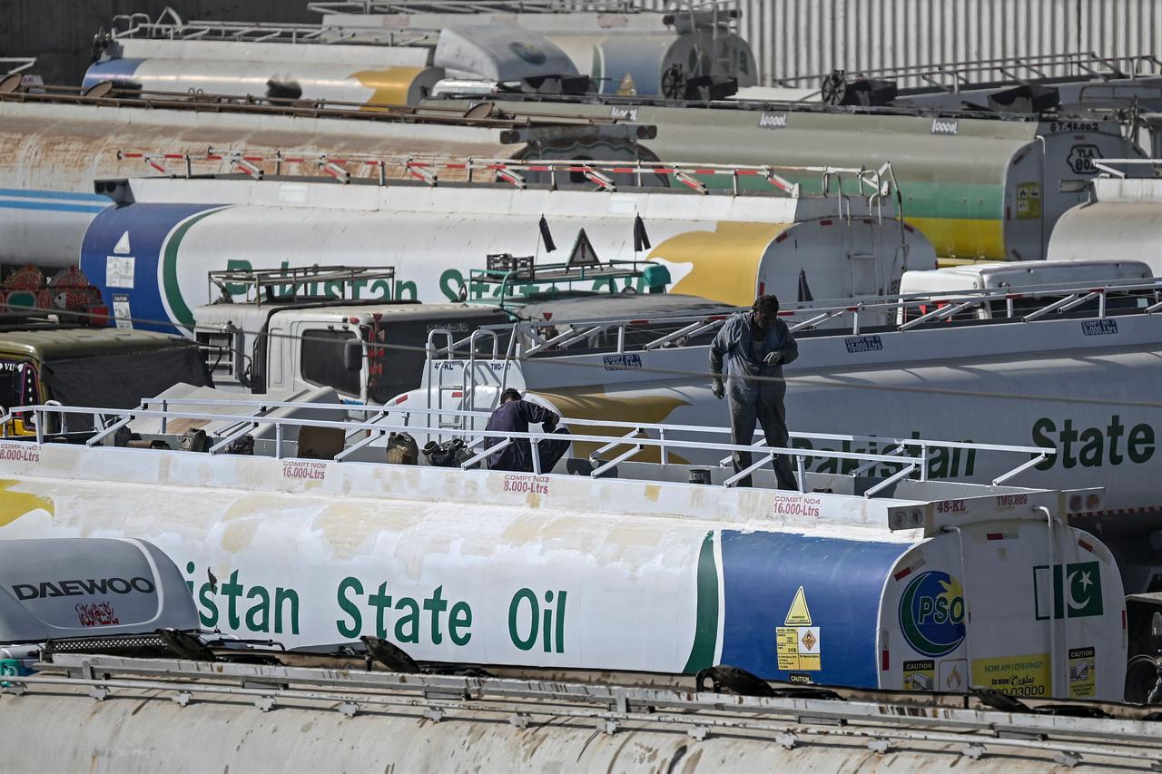 Workers stand on top of an oil tanker parked near an oil storage terminal in Karachi on March 12, 2026 as global energy markets face disruptions amid ongoing conflict in the Middle East. (AFP Photo)