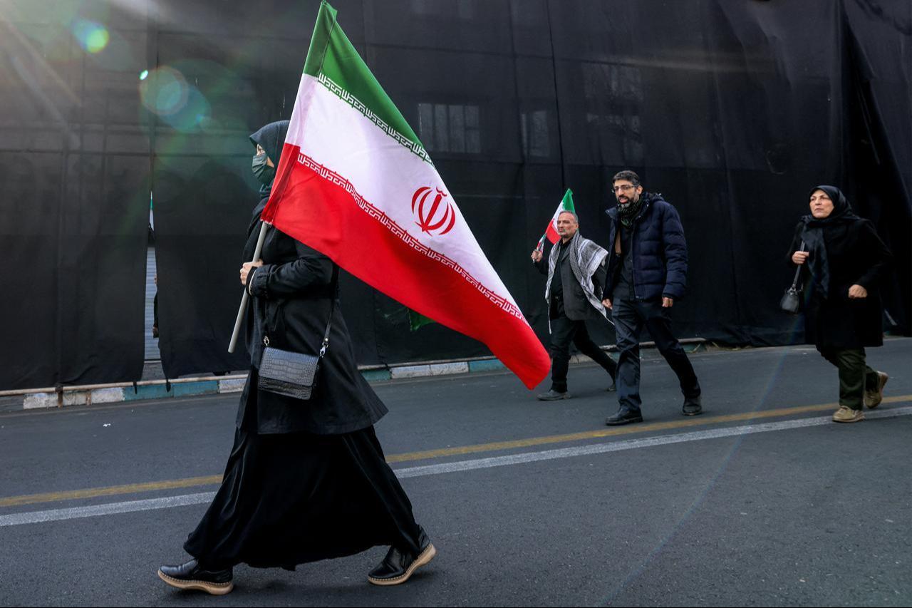 Demonstrators march with Iranian national flags to a rally in support of the new Supreme Leader at Enghelab Square in central Tehran on March 9, 2026. (AFP Photo)