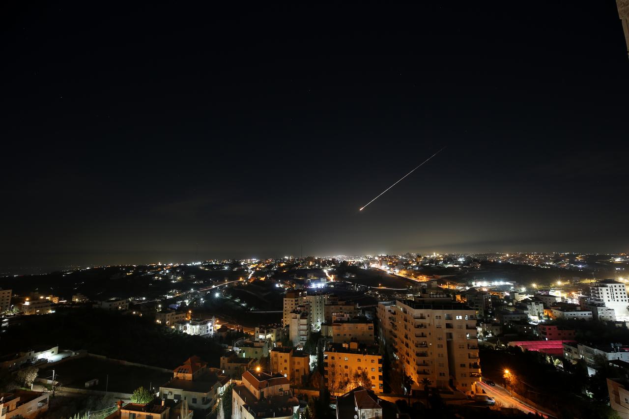 Missiles launched from Iran in retaliation for Israeli attacks are seen in the night sky over the city of Hebron in the West Bank, March 12, 2026. (AA Photo)