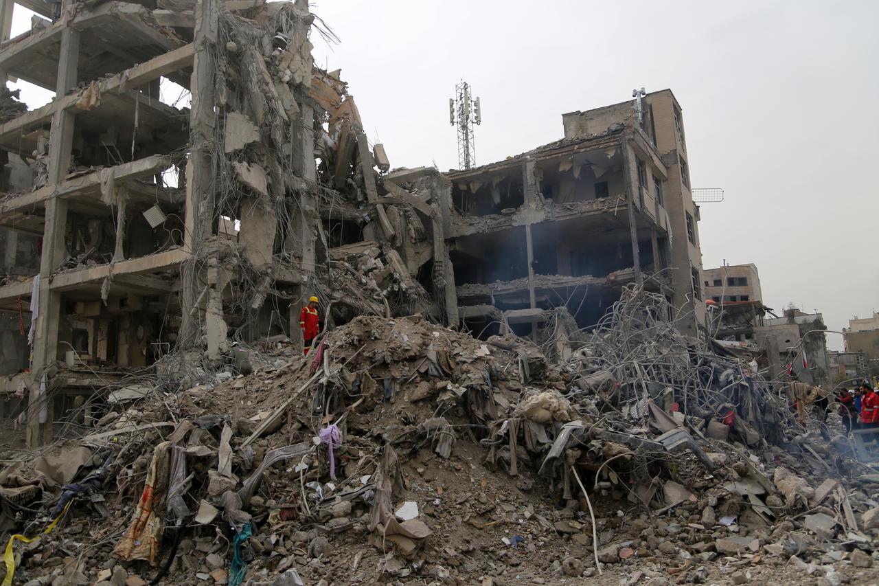 A search and rescue member inspects the site among the rubble of a damaged building near Risalat Square following Israeli and US strikes that caused heavy destruction in eastern Tehran, Iran on March 12, 2026. (AA Photo)
