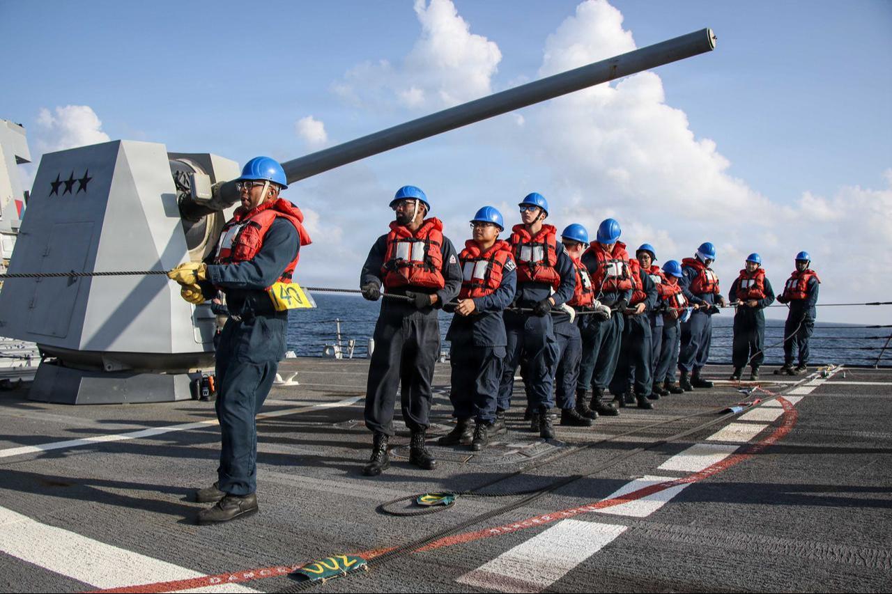 U.S. Sailors man a phone-and-distance line on the forecastle of Arleigh Burke-class guided-missile destroyer USS Frank E. Petersen Jr. (DDG 121), during a replenishment-at-sea in the Arabian Sea, Feb. 18, 2026. (Photo via U.S. Navy)