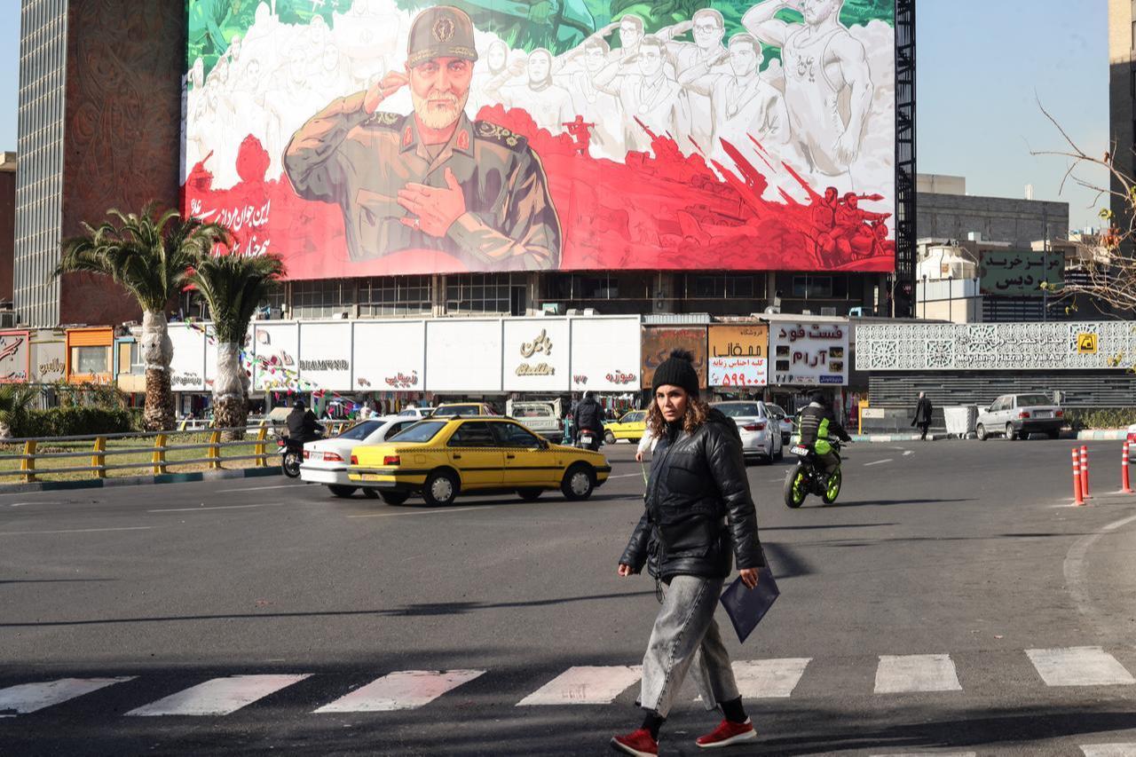 Iranians ride their motorbike past a huge banner of former Iran Islamic Revolutionary Guard Corps (IRGC) Quds Force commander Qasem Soleimani in Tehran, Dec. 31, 2025. (AFP Photo)