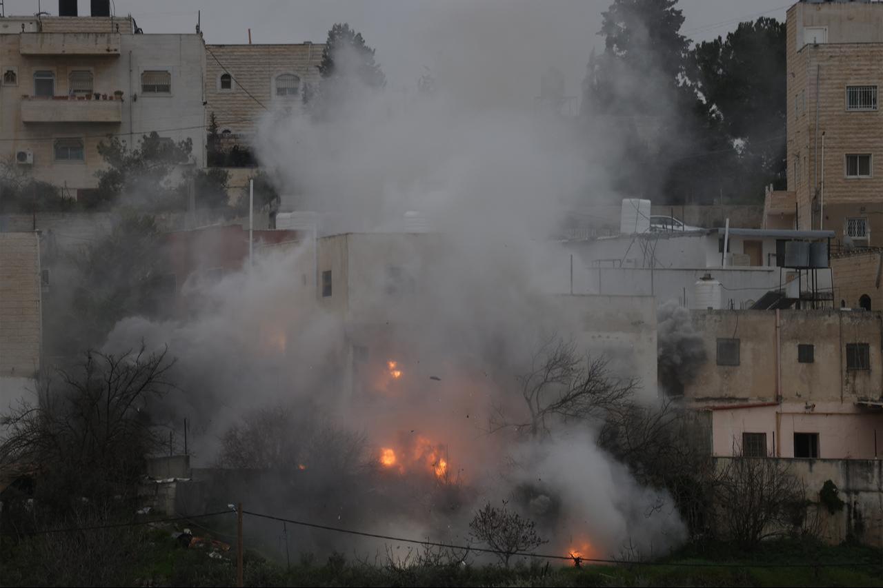Smoke and dust rise as the Israeli military destroys the home of Palestinian prisoner Azmi Abu Hlayel, in the Israeli-occupied West Bank city of Hebron on March 14, 2026. (AFP Photo)