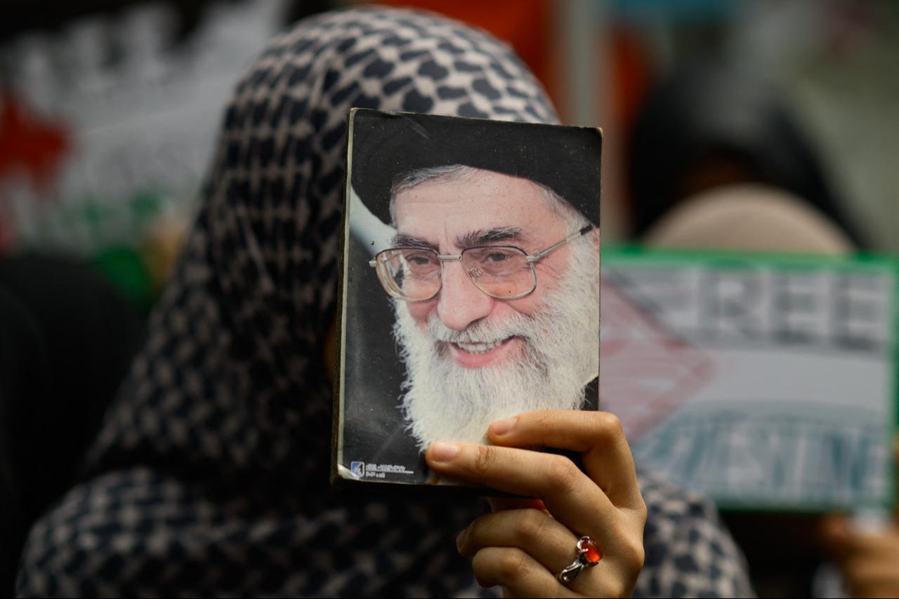 A woman holds a portrait of Iran's slain supreme leader Ali Khamenei as she participates in Al-Quds (Jerusalem) Day rally outside the Israeli embassy in Bangkok, March 13, 2026. (AFP Photo)