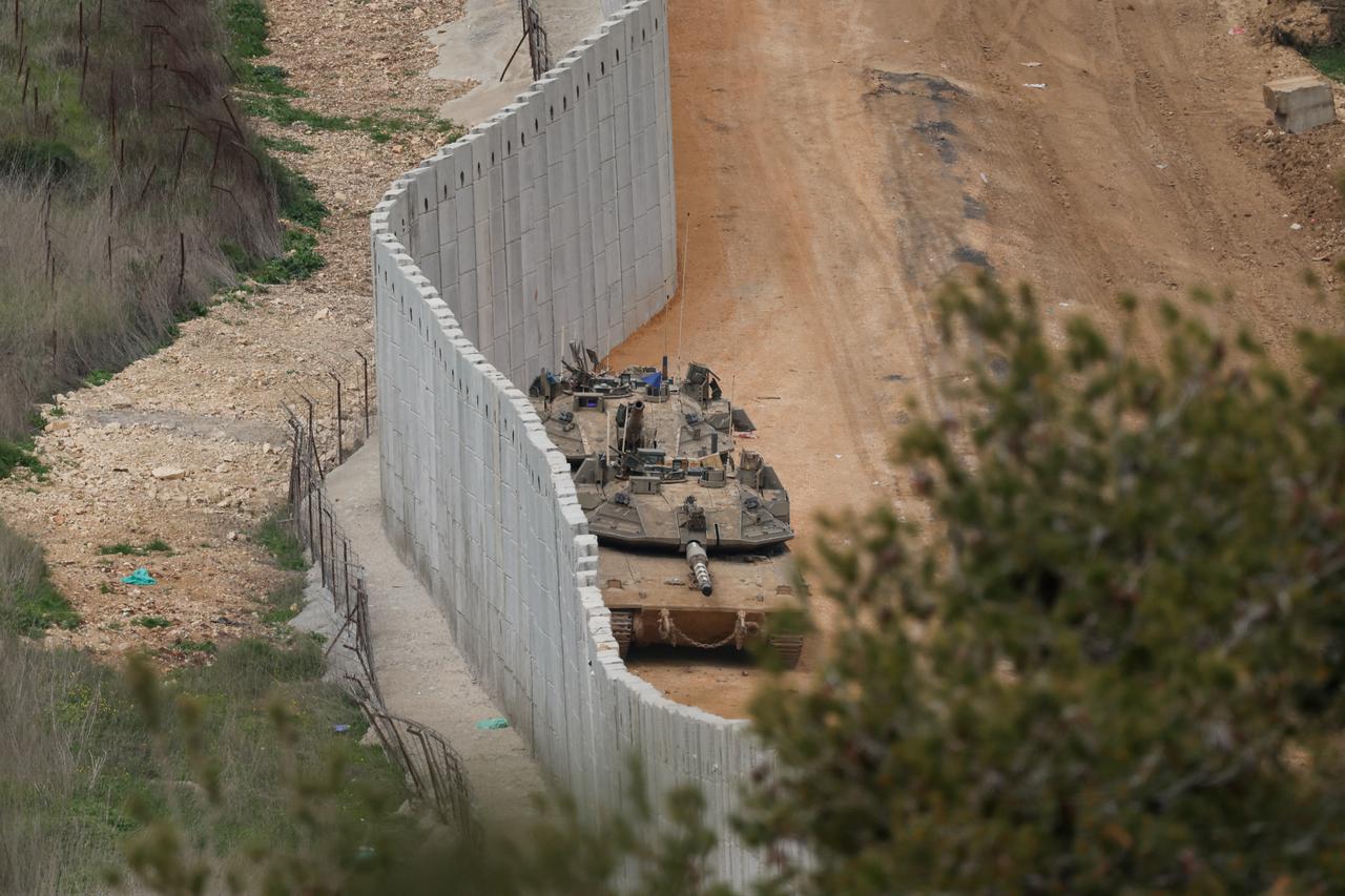 Israeli army tanks take position along the border wall in the upper Galilee near the Israel-Lebanon border on March 14, 2026. (AFP Photo)