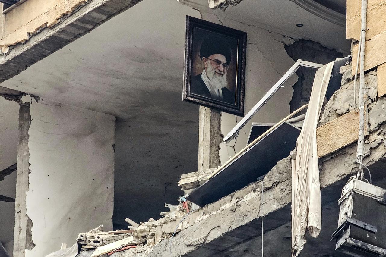 A portrait of Iran’s late Supreme Leader Ali Khamenei is seen hanging on the wall of a destroyed building, the site of an Israeli airstrike in Beirut’s southern suburb of Haret Hreik, March 15, 2026. (AFP Photo)