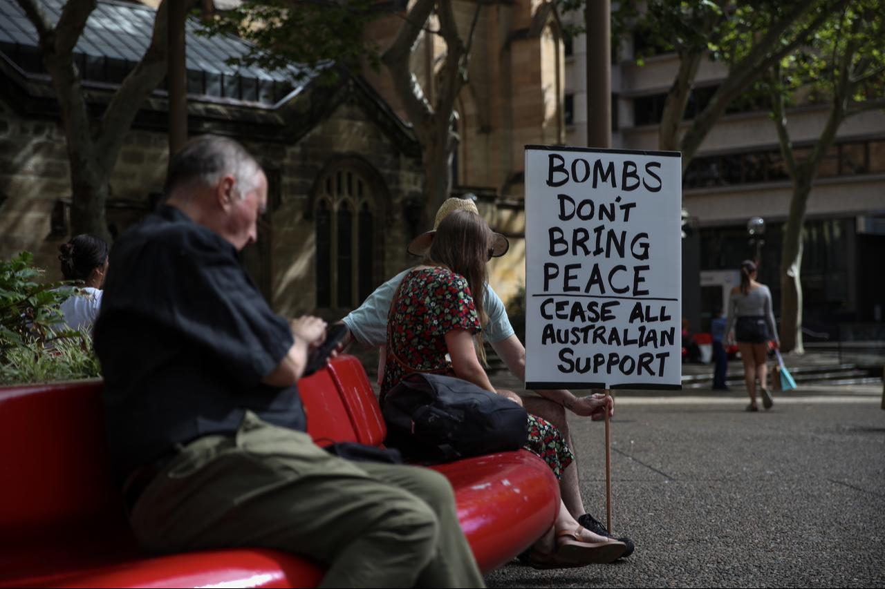Protesters hold a sign duringa rally outside Sydney Town Hall on March 14, 2026, in Sydney, Australia. (AA Photo)