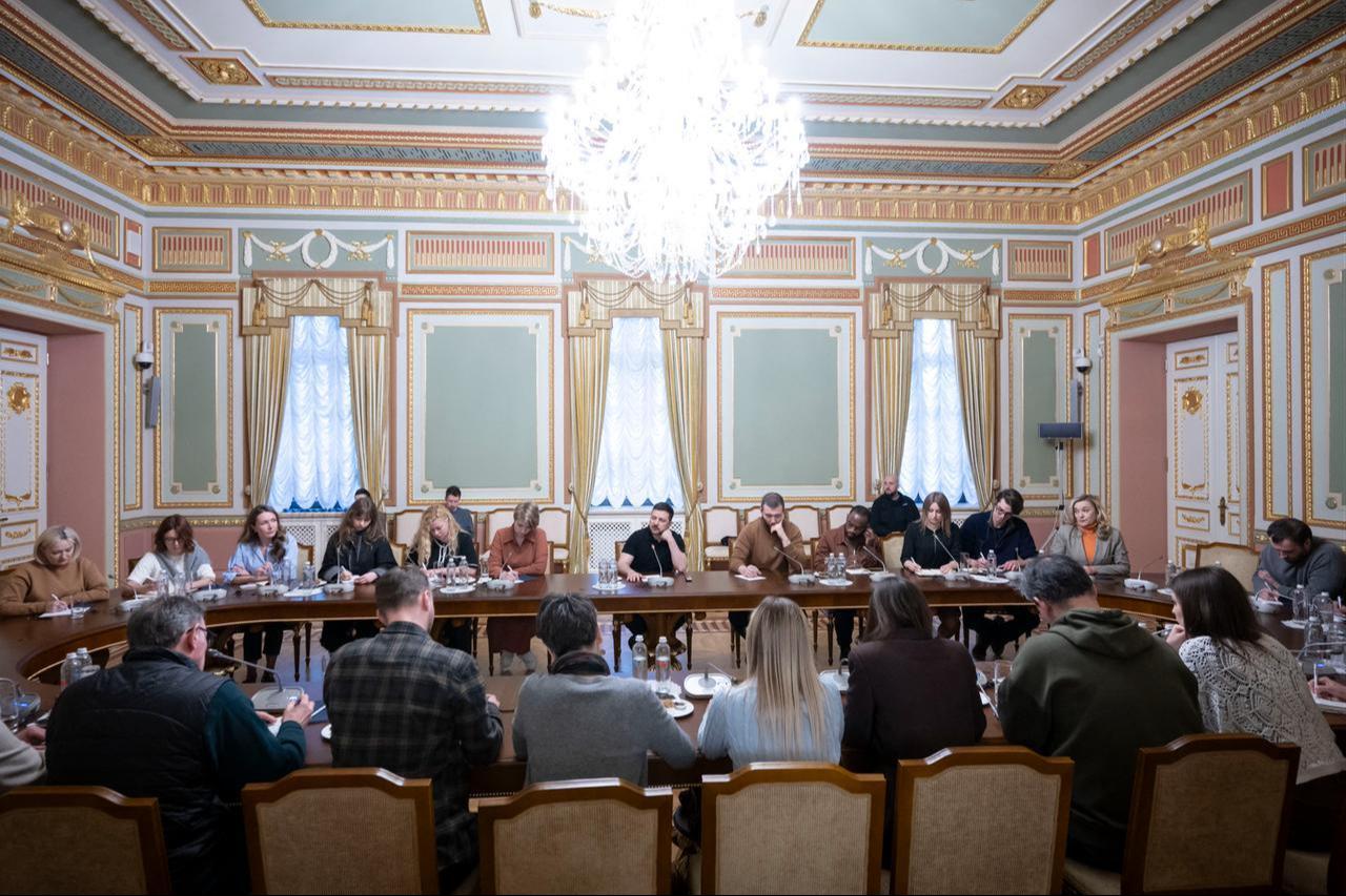 In this handout photograph taken on March 14, 2026, Ukraine's President Volodymyr Zelenskyy (C) attends a meeting with journalists at his office in Kyiv. (Photo by Handout/Ukrainian Presidential Press Service/AFP)