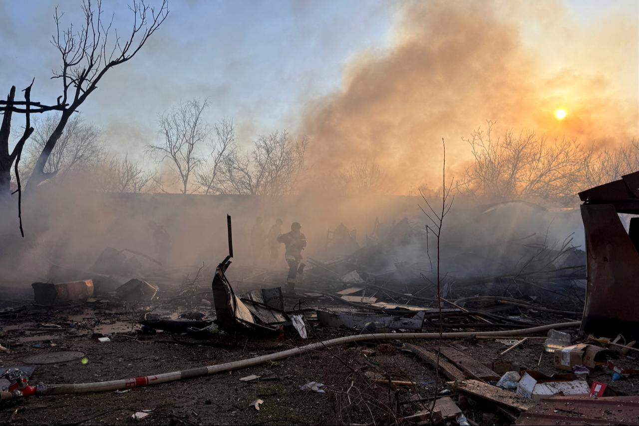 Ukrainian rescuers work to extinguish a fire at the site of an air attack in Zaporizhzhia on March 14, 2026, amid the Russian invasion of Ukraine. (AFP Photo)