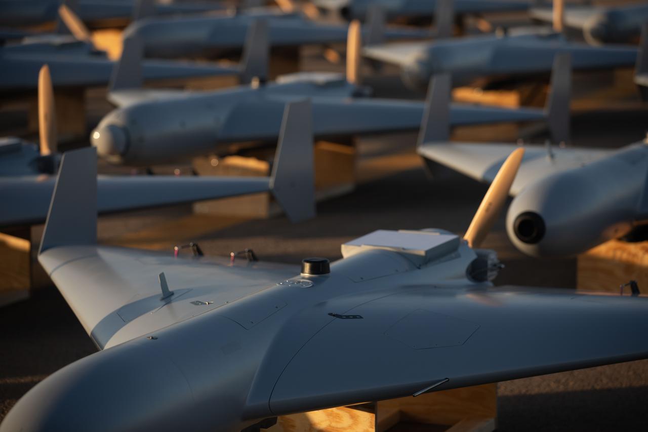 Low-cost Unmanned Combat Attack System (LUCAS) drones are positioned on the tarmac at a base in the U.S. Central Command (CENTCOM) area of operations, Nov. 23, 2025. (Photo via CENTCOM)