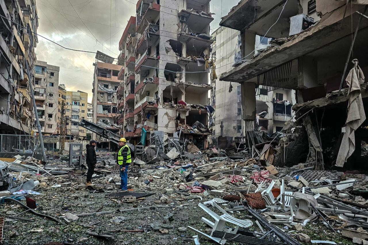Men inspect a site of overnight Israeli airstrikes in the southern suburbs of Beirut on March 16, 2026. (AFP Photo)