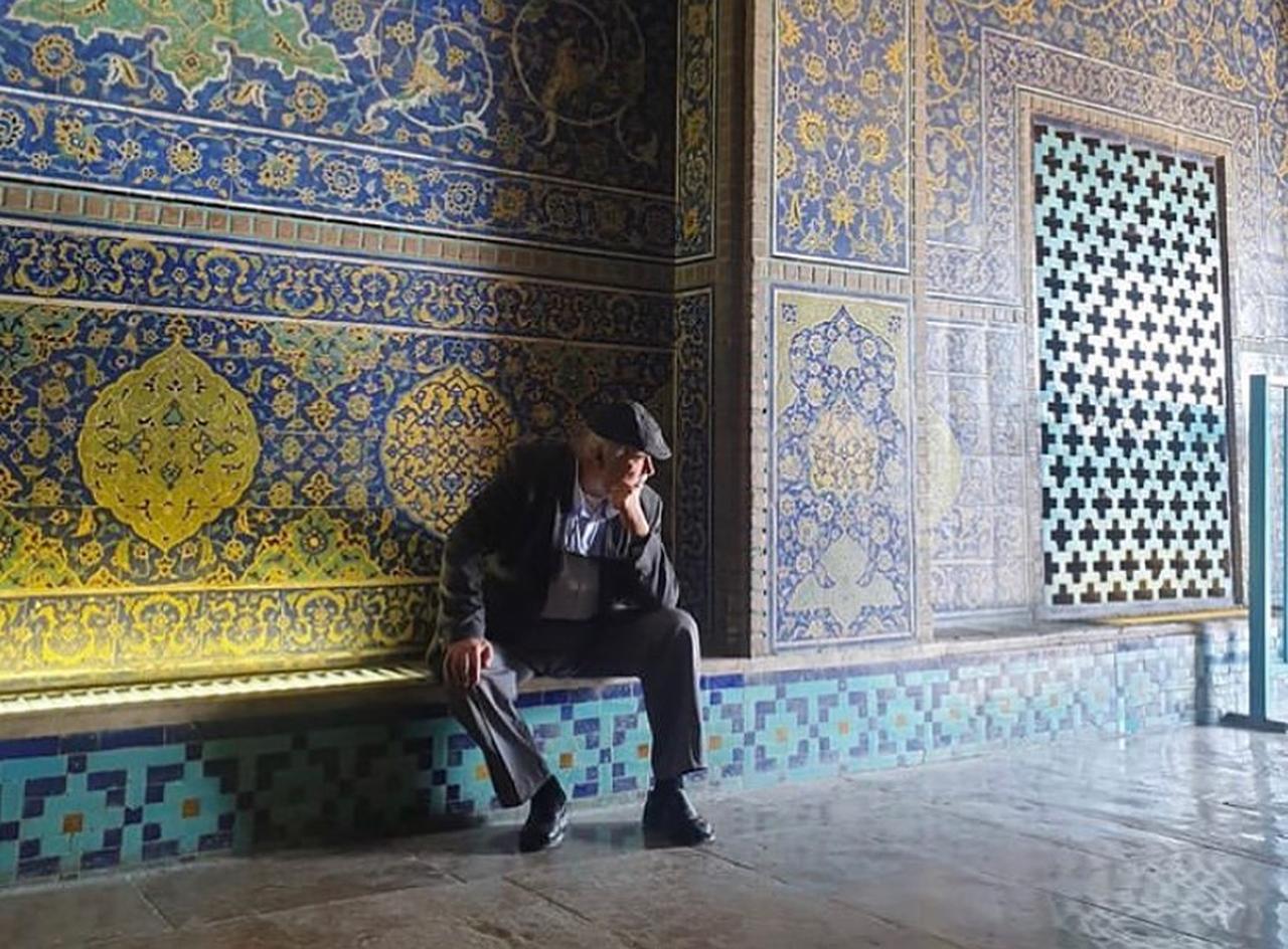 Professor Ilber Ortayli sits inside the richly decorated interior of Sheikh Lutfollah Mosque, reflecting his long-standing interest in Persian architecture and the cultural ties linking Iran and the wider Ottoman world, July 28, 2020. (Photo via Instagram/@ilberortayli)