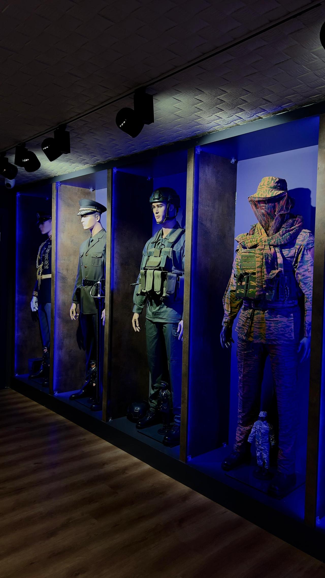 Assorted military uniforms from different countries, featuring both camouflage and plain designs in varied colors, each tailored for distinct functions. (Nour Dajani/Türkiye Today)