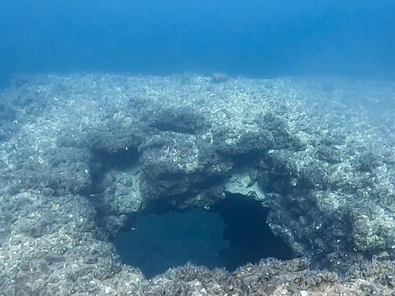 A submerged rock formation and structural remains lie on the floor of the Dicle Dam reservoir, Diyarbakir, Türkiye, March 18, 2026. (AA Photo)
