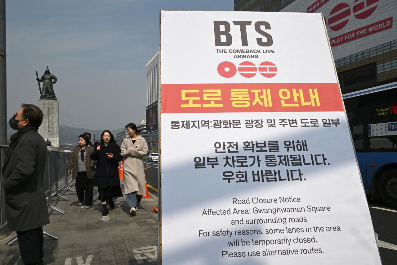 Pedestrians pass a road closure notice for a BTS comeback concert at Gwanghwamun Square in Seoul, South Korea, March 16, 2026. (AFP Photo)